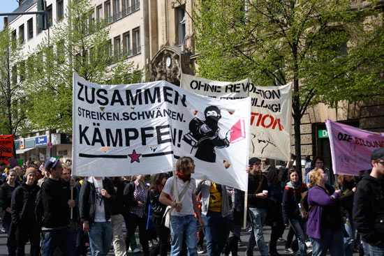 A number of large banners, including one asking for a revolution and one saying &ldquot;Zusammen Streiken. Schwänzen. Kämpfen!&rdquot; (Together Strike. Skip. Fight!