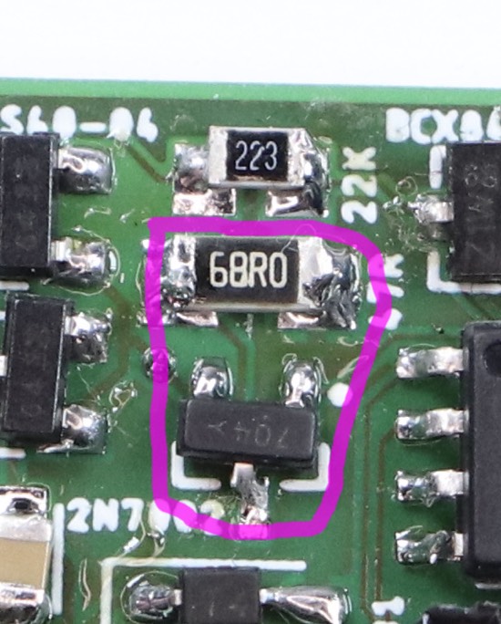 Excerpt from the photograph of the circuit board. A different small piece with three pins highlighted together with a different resistor.